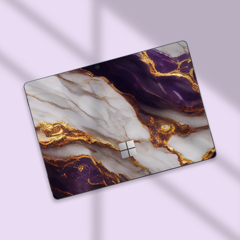 a computer mouse pad with a purple and gold design