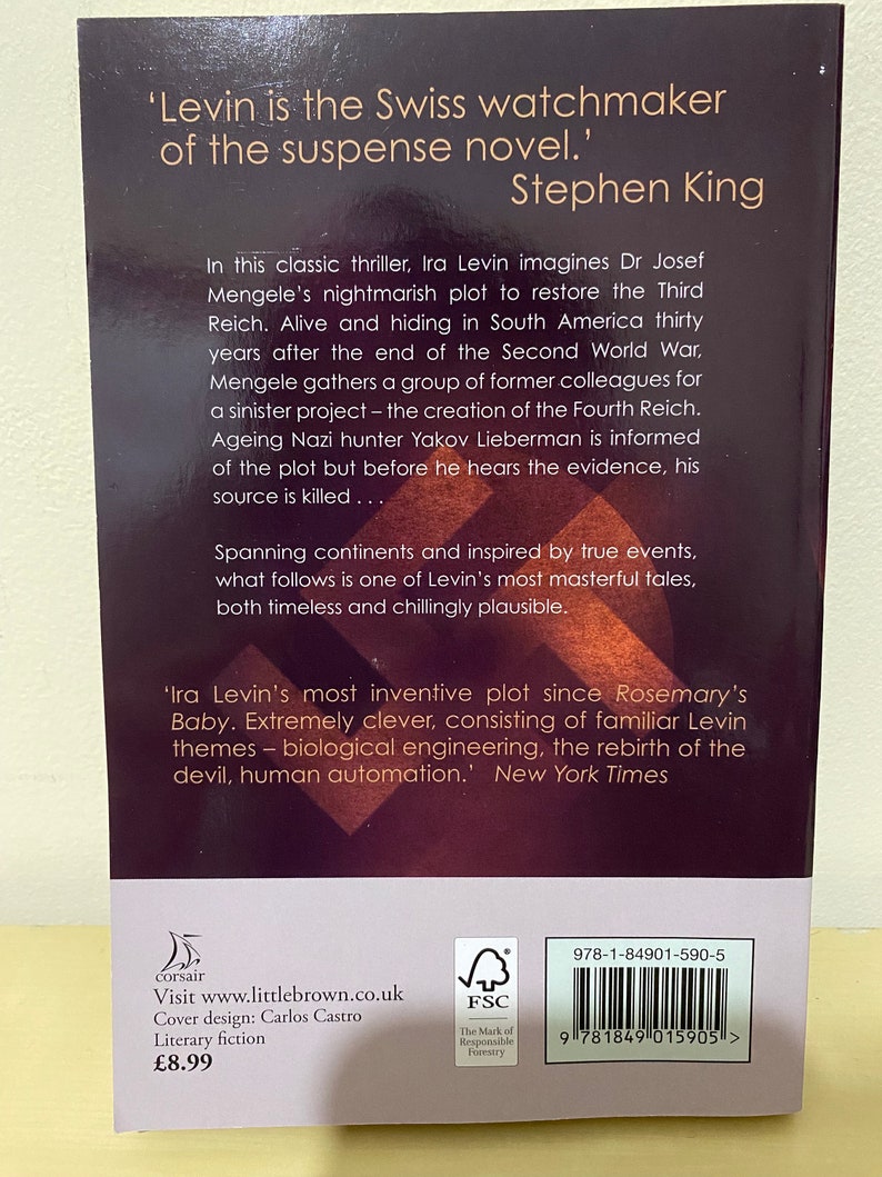 May include: Book cover for the novel "The Swiss Watchmaker" by Ira Levin. The cover features a dark background with white text. The text includes a quote from Stephen King, "Levin is the Swiss watchmaker of the suspense novel." and a blurb about the book.