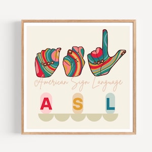 May include: A framed print featuring colorful hand gestures representing letters in American Sign Language. The print includes the text "American Sign Language" and the letters "A", "S", and "L" in a playful font.