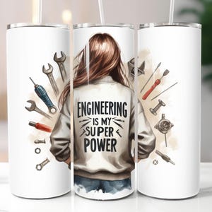 May include: White stainless steel tumbler with a graphic of a woman with brown hair wearing a jacket with the text "Engineering is my super power" and tools surrounding her.