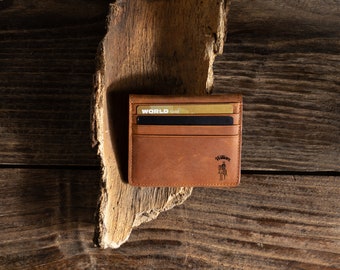 May include: A brown leather wallet with a gold card inside. The wallet has the text "WORLD Gold" and "Walkern" on it.