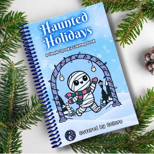 May include: A blue and white colouring book with a spiral binding. The cover features a cartoon mummy in a winter wonderland setting with the title "Haunted Holidays: A Simple Spooky Colouring Book" and the text "Covered by Colors".