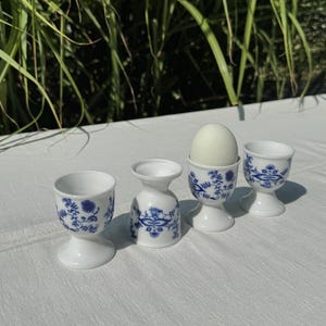 A set of 4 Vintage white porcelain with a Blue Danube Onion motif egg cups