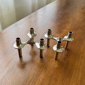 Two vintage MCM metal “Orion” candleholders by Ceasar Stoffi & Fritz Nagel for BMF, Mid Century Modern silver stackable candle stick holders