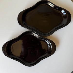 a set of two black wavy vintage decorative plates/platters