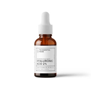 May include: A brown glass bottle with a white dropper and a white label. The label reads "THE ESSENTIAL HOUSE" and "HYALURONIC ACID 2%" with additional text about the product's benefits. The bottle is for a skin protection serum.