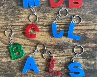 Hand-made resin capital letter initial keyrings.