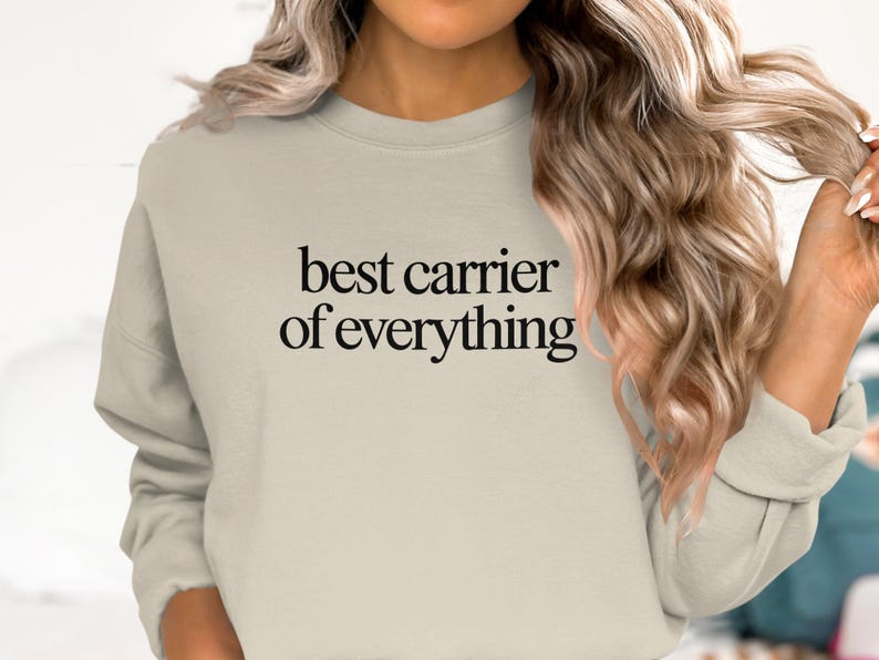 Crewneck sweatshirt with "best carrier of everything" text on chest.