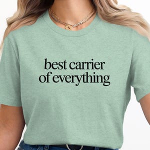 Pale green t-shirt with black text reading "best carrier of everything".