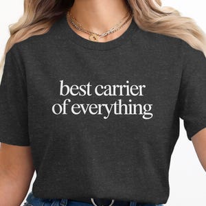 Dark grey t-shirt with "best carrier of everything" in white text.
