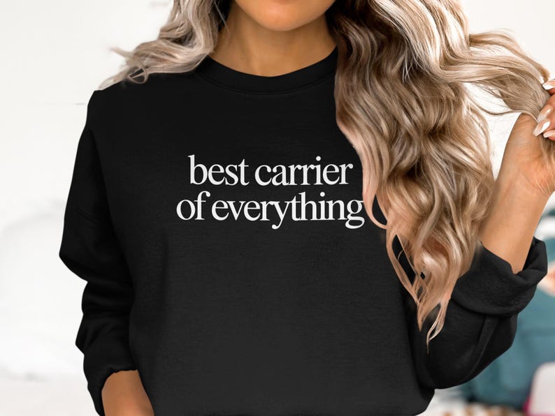 Black sweatshirt with "best carrier of everything" text in white.