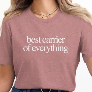 Dusty rose t-shirt with "best carrier of everything" printed in white text.