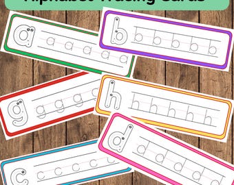 May include: Alphabet tracing cards with colorful borders. Each card features a lowercase letter and dotted lines for tracing. The cards are arranged on a wooden surface. The text "Alphabet Tracing Cards" is at the top.