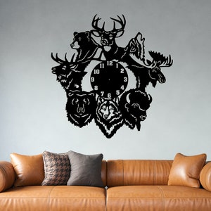 May include: Black metal wall clock with a circular clock face and Roman numeral hour markers. The clock is surrounded by animal silhouettes, including a deer, bear, wolf, moose, and bison.