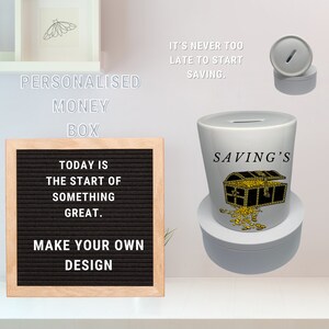 May include: White ceramic money box with a gold treasure chest and coins design. The text "SAVING'S" is printed on the front of the box. The money box is on a white shelf with a letter board that says "TODAY IS THE START OF SOMETHING GREAT. MAKE YOUR OWN DESIGN".