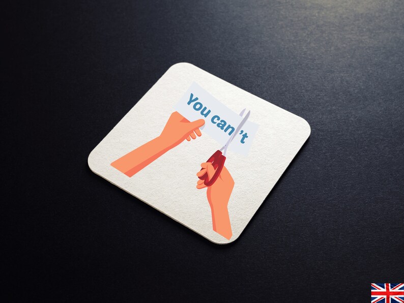 K&ouml;nnte beinhalten: Ein wei&szlig;er Untersetzer mit einer Cartoon-Illustration einer Hand, die eine Schere h&auml;lt und das Wort "You can't" von einem St&uuml;ck Papier schneidet.