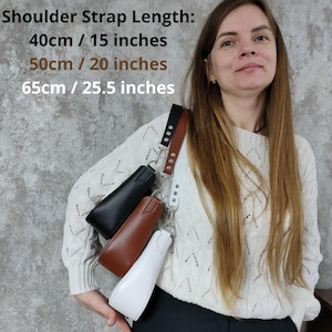 May include: A woman is wearing a white sweater and is holding three different colored bags. The bags are black, brown, and white. The shoulder strap length options are listed as 40cm/15 inches, 50cm/20 inches, and 65cm/25.5 inches.