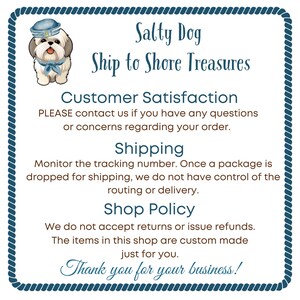 May include: A square sign with a blue rope border featuring a cartoon dog wearing a sailor hat and scarf. The text reads: Salty Dog Ship to Shore Treasures, Customer Satisfaction, Shipping, Shop Policy, and Thank you for your business!