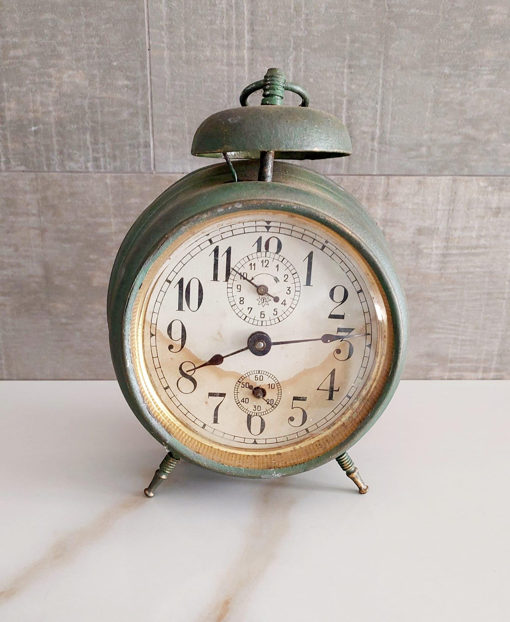 Antique alarm clock from the 1930s, mechanical table clock. Antique decoration. Vintage clock, retro alarm clock, collector's clock.