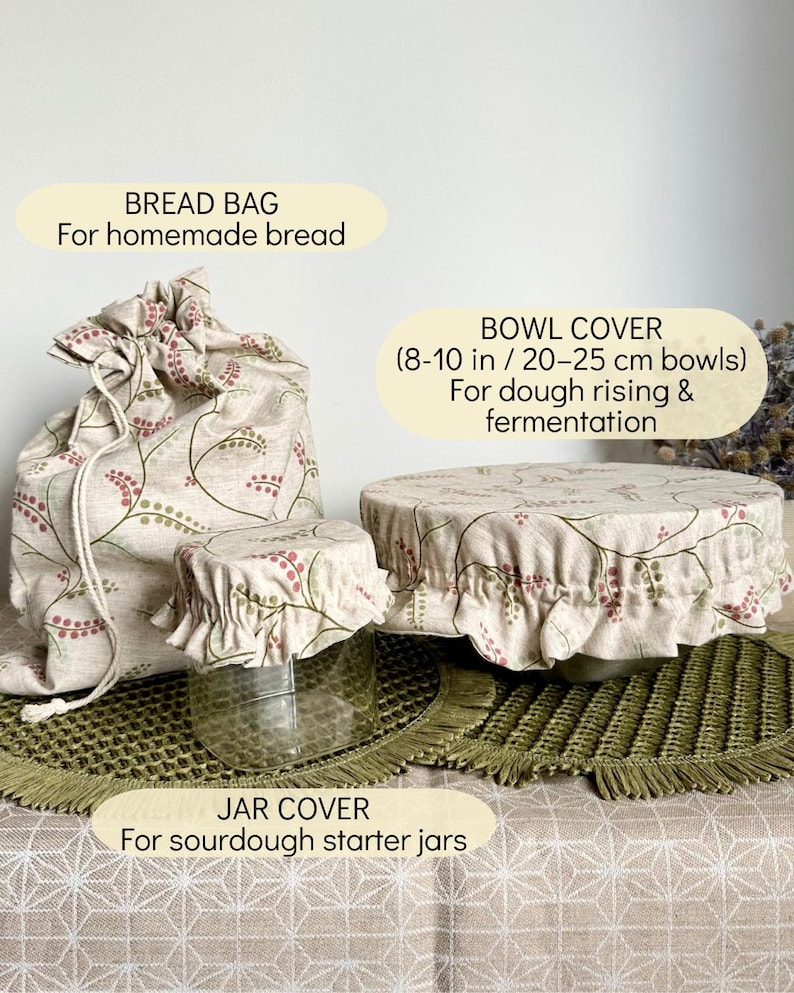 May include: A beige fabric bread bag, a small jar cover, and a large bowl cover, all featuring a botanical pattern of red and green berries on thin vines. The bowl cover is labeled for 8-10 inch bowls, while the jar cover is for sourdough jars.