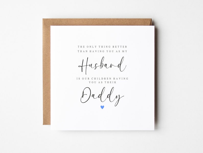 May include: A white card with black text that reads "The only thing better than having you as my Husband is our children having you as their Daddy." A small blue heart is at the bottom of the card.