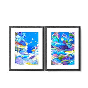 May include: Two framed prints of colorful underwater scenes depicting coral reefs and fish. The prints are in black frames with white mats.