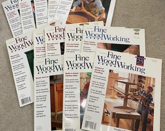 May include: A collection of "Fine Woodworking" magazines, featuring articles on woodworking techniques and projects. The covers display images of woodworking projects and tools, with titles like "Build a tilt-top table" and "Build a classic kitchen table."