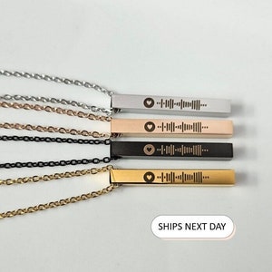 May include: Four necklaces with bar pendants in silver, rose gold, black, and gold. Each pendant features a heart symbol and a unique sound wave pattern. The chains are in matching colors. The image includes the text "SHIPS NEXT DAY".