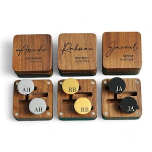 May include: Three wooden boxes with engraved names, dates, and titles like "Groom", "Bestman", and "Groomsman". Each box contains a pair of cufflinks with initials.