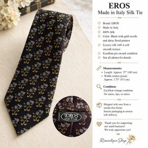 May include: A black silk tie featuring a repeating pattern of gold scrolls and white daisy flowers. The tie measures 57 inches in length and 3.75 inches at its widest point. A circular inset shows the back label reading EROS Made in Italy.