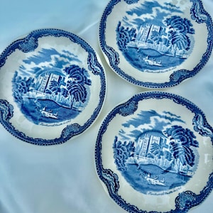 Puede incluir: Tres platos de cer&aacute;mica blanca con un dise&ntilde;o azul y blanco. Cada plato presenta una escena de paisaje con un edificio, &aacute;rboles y un barco. Los platos tienen un borde festoneado y el texto "Kenilworth Castle in 1792".