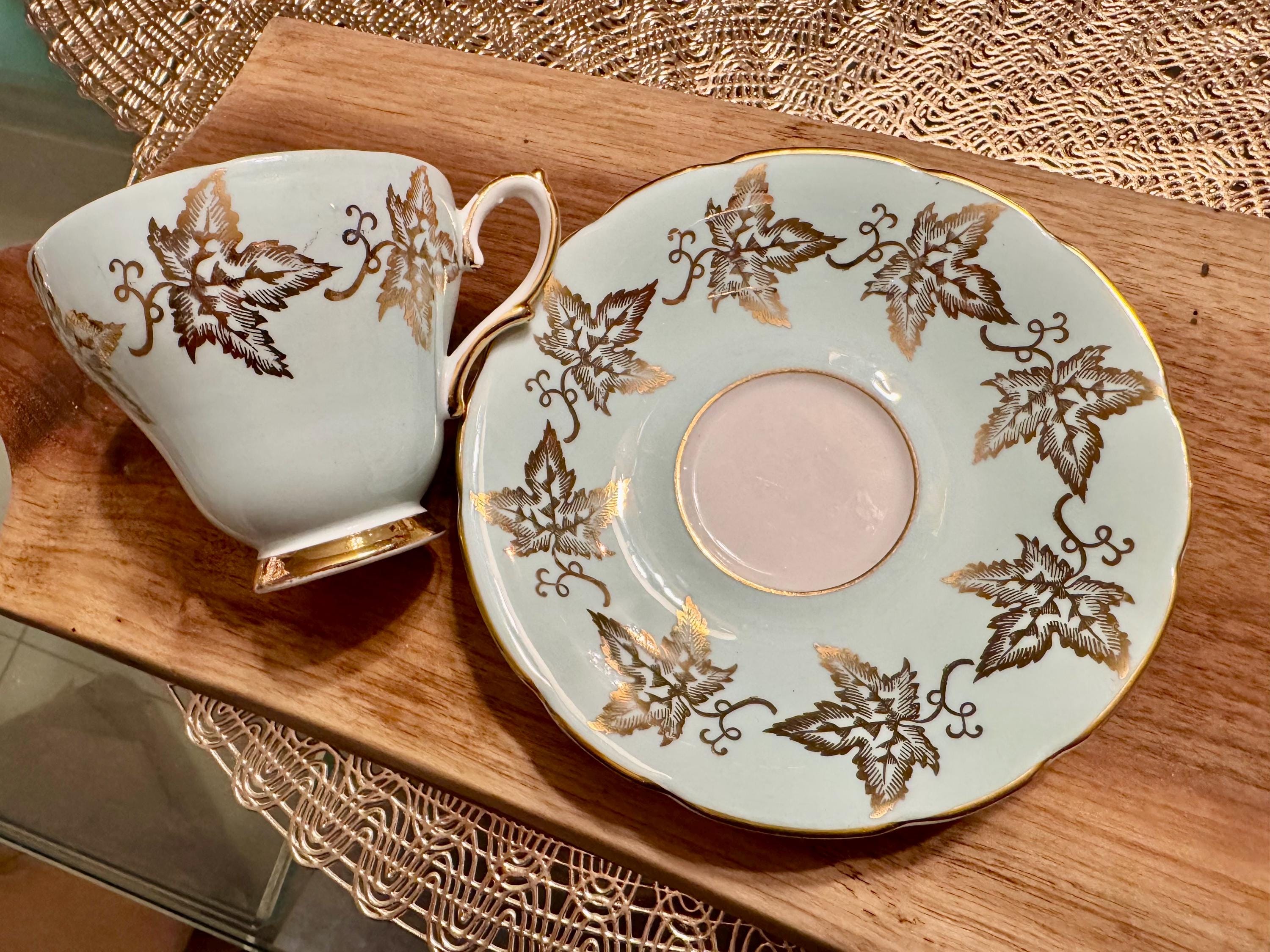 Vintage Sutherland Bone China Cup and Saucer: Pale Blue, Gold Leaves, Pink Roses