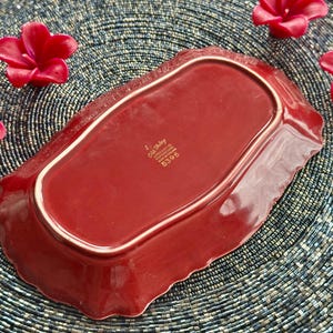 May include: A red ceramic serving dish with a scalloped edge. The dish has a gold rim and the words "Old Bailey" and "England" are printed in gold on the bottom. The number "5396" is also printed in gold.