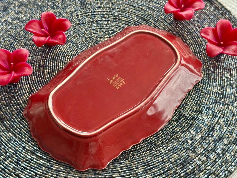 May include: A red ceramic serving dish with a scalloped edge. The dish has a gold rim and the words "Old Bailey" and "England" are printed in gold on the bottom. The number "5396" is also printed in gold.