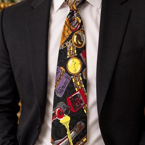 May include: A black necktie featuring a vibrant, multi-colored print of various objects including a yellow pocket watch, a red key tag, a yellow key, and purple currency notes, all set against a dark background with a subtle, swirling pattern.