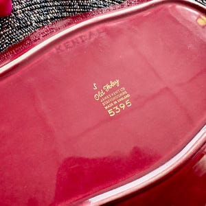May include: A red ceramic serving dish with a gold inscription that reads "Old Foley, James Kent Ltd, Staffordshire, Made in England, 5395".