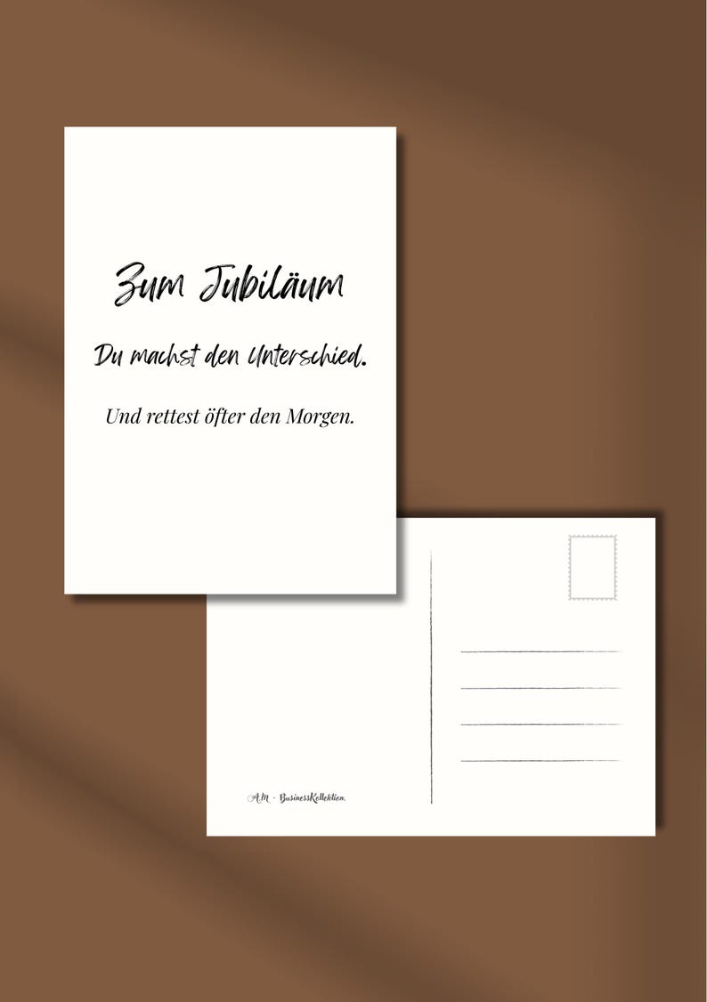 May include: Two white postcards on a brown background. The front postcard has black text that reads "Zum Jubil&auml;um, Du machst den Unterschied, Und rettest &ouml;fter den Morgen." The back postcard has lines for writing.