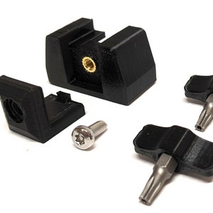 May include: A set of black plastic 3D printed parts for a camera mount, including a base, a bracket, a screw, and two screwdriver tools.