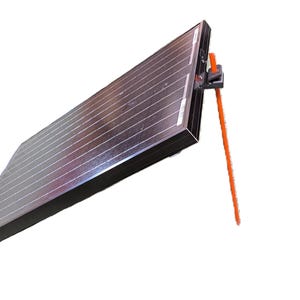 May include: A rectangular solar panel with a dark surface and white grid lines. It is mounted on a black bracket with an orange support rod, designed to prop the panel up. The panel is angled, suggesting it's for capturing sunlight.