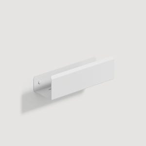 May include: A matte white metal wall-mounted shelf featuring a simple U-shaped profile with a flat base and a tall front lip. The side panel includes a circular mounting hole and a horizontal slot for secure attachment to a flat vertical surface.