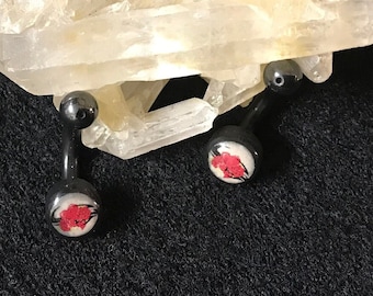Paire de faux percing «cœur et fleurs », paire de boucles d’oreilles souples en acrylique noir avec fleurs et cœur rouge sur fond blanc