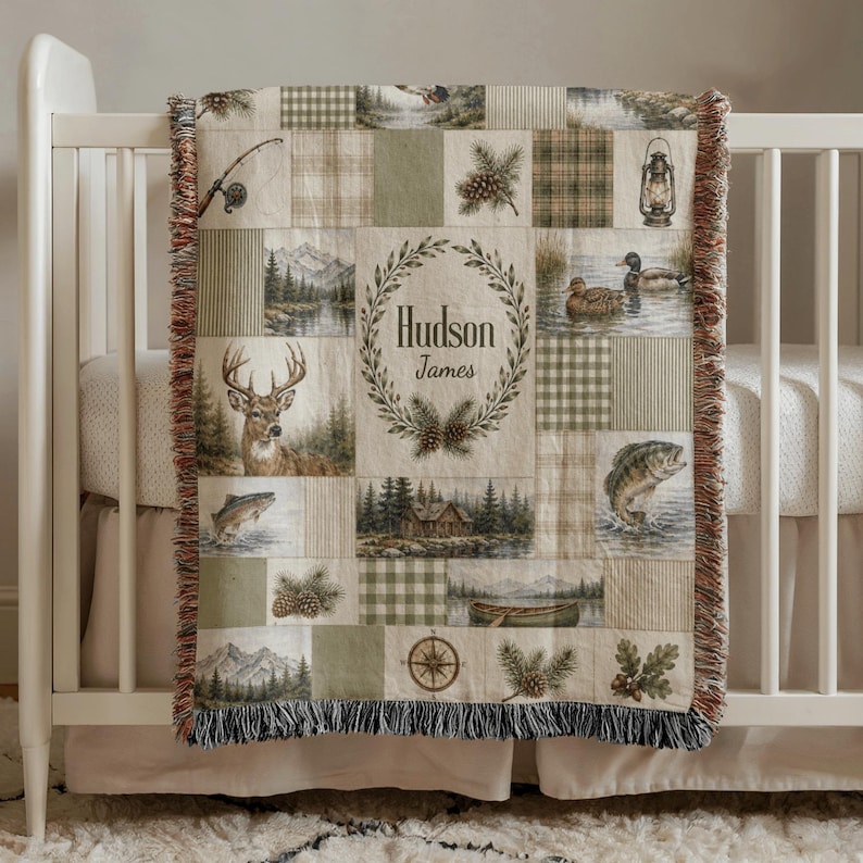 Personalized woven hunting and fishing baby blanket featuring deer, mallard ducks, bass fish, rustic cabin, lake, canoe, pinecones, woodland patchwork, custom baby name, outdoor nursery decor, baby shower keepsake.