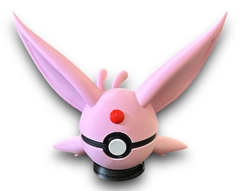 May include: Pink 3D printed Pokemon figurine of a Eevee with large ears and a Pokeball design on its chest.