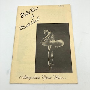 May include: A vintage Ballet Russe de Monte Carlo program from the Metropolitan Opera House, dated 9/28/49. The cover features a black and white photograph of a ballerina in a tutu performing on stage against a cream-colored background.