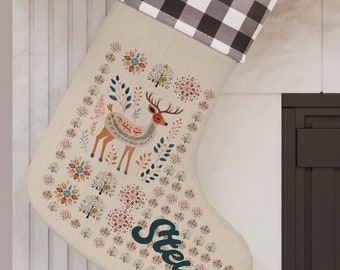 May include: A Christmas stocking with a beige background, a black and white checkered cuff, and a deer and floral design. The name "Steve" is printed in green script. A red and white swirled lollipop and a wrapped gift are visible.