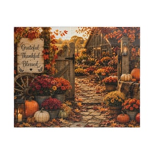 May include: A jigsaw puzzle depicting an autumn scene with a wooden gate, a sign reading Grateful Thankful Blessed, orange pumpkins, and pots of red, orange, and yellow chrysanthemums. The landscape features a rustic barn, fallen leaves, and lanterns.