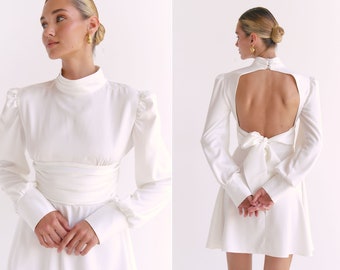 Bridal white mini dress with open back. Turtleneck backless silk dress with circle skirt and long puff sleeves. Satin wedding dress.