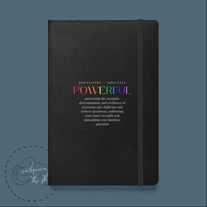 May include: Black notebook with a rainbow colored word "POWERFUL" and a definition of the word. The notebook has a black elastic band.