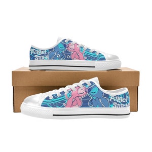 May include: White canvas low-top sneakers with a blue and pink cartoon design of Stitch and Angel from Lilo & Stitch. The text "Angel Stitch" is printed on the side of the shoes.