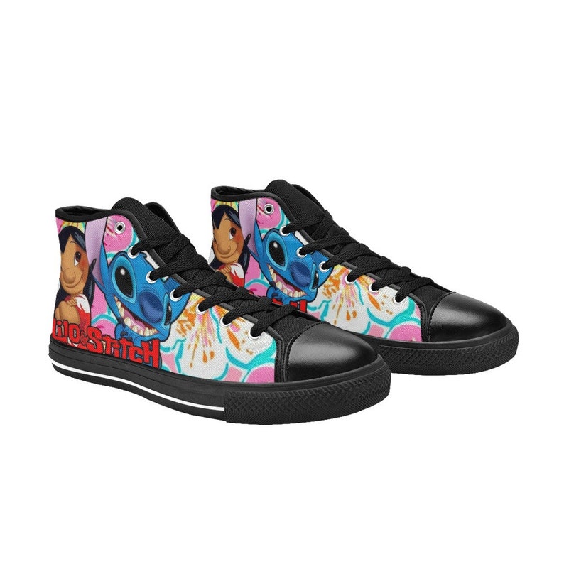 Op de afbeelding: Zwarte high-top canvas schoenen met een kleurrijke print met Stitch en Lilo uit de Disney-film Lilo & Stitch. De print bevat roze bloemen en de woorden "Lilo & Stitch".